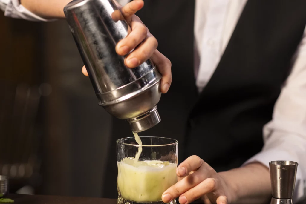 Bartender serving drink out of shaker - Regatta Grove Bartender serving drink out of shaker
